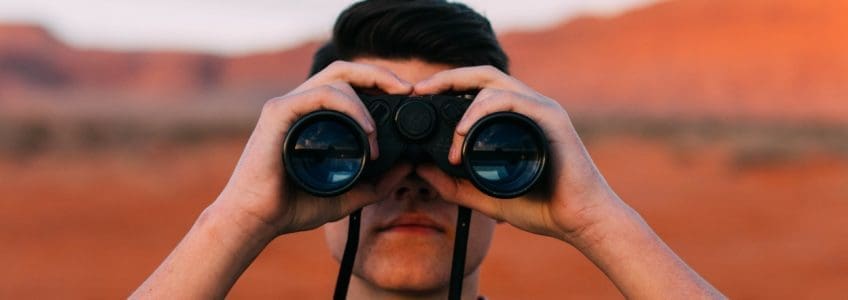 binoculars in red rock landscape