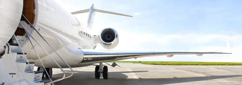 airplane with steps down sits on tarmac