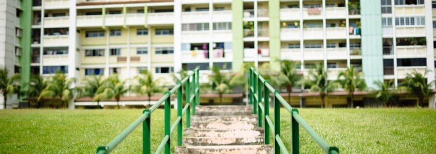 steps and green railings going up to residential buildings