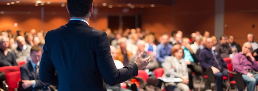 A man speaking at a business conference